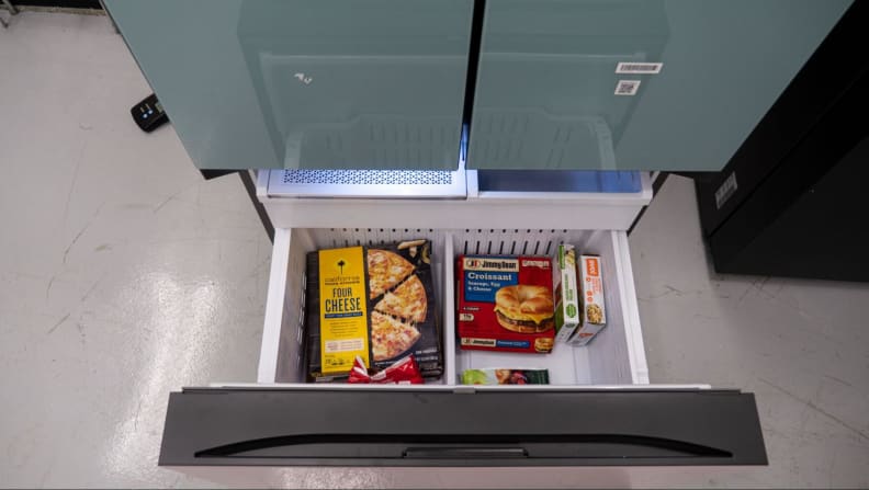 Upper view of a lower freezer stocked with frozen food.