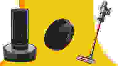 a black iRobot robot vacuum and dock, a black eufy robot vacuum, a Dyson vaccum