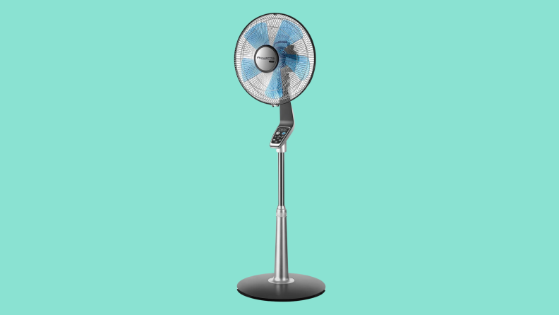 A tall pedestal fan appears on a teal background.