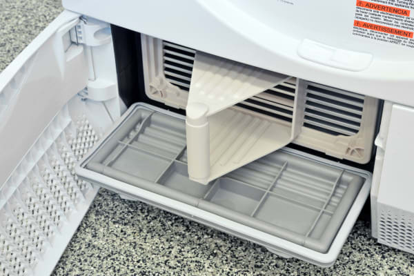Once the secured panel has been released, pull the Electrolux EIED200QSW's condenser out by its handle.
