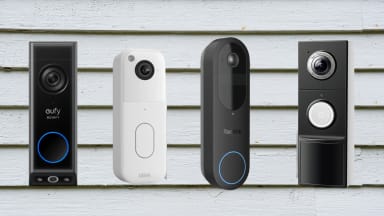 Four video doorbells sit on a house clapboard