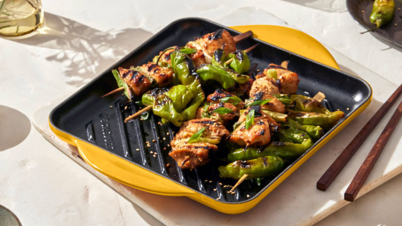 Lovely protein kababs are served atop a yellow Le Creuset Signature Square Grill.