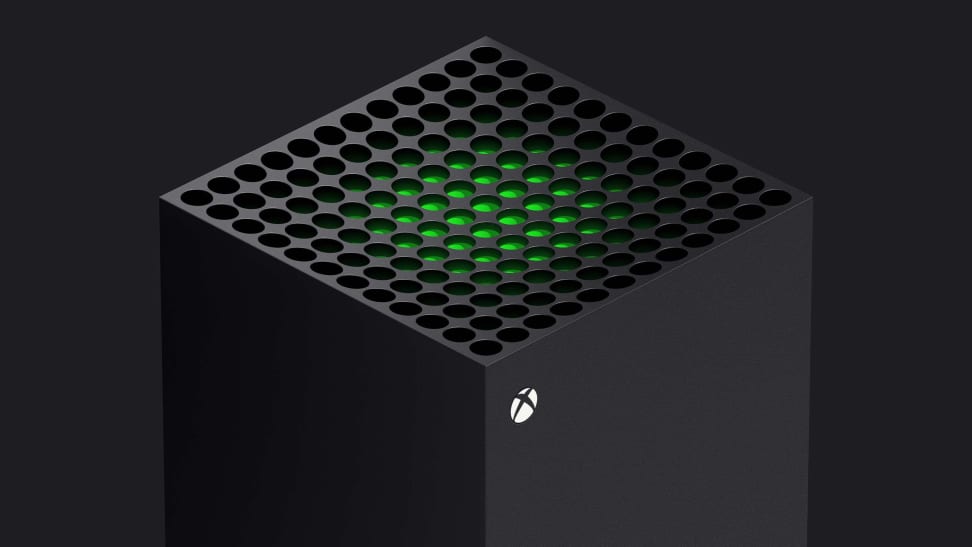 The top of a gaming console with a glowing green center