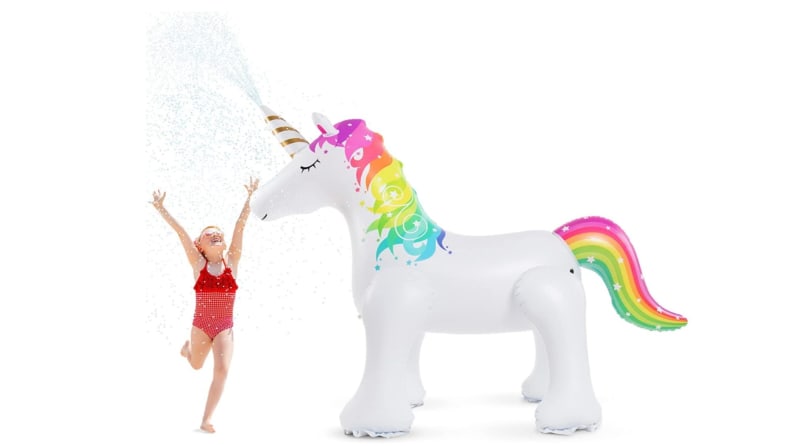 A little girl runs through water sprayed by a unicorn sprinkler