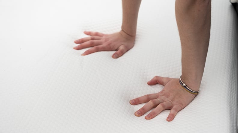 hands press into the lull original's surface