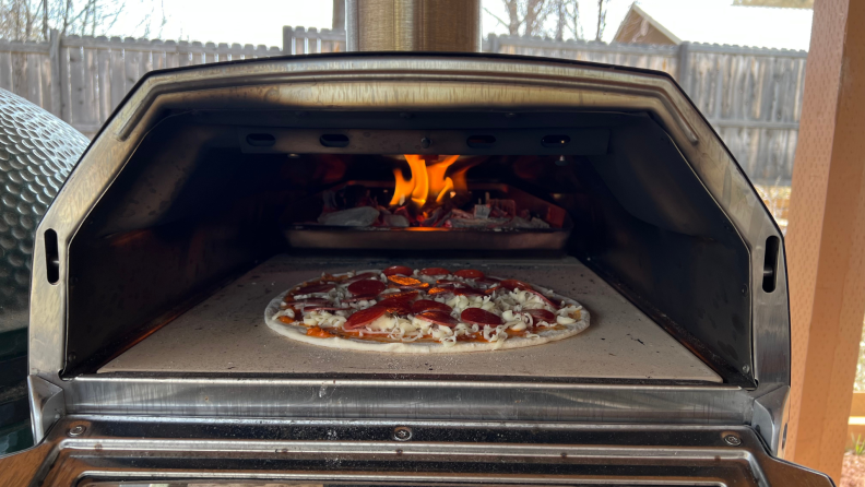 A pepperoni pizza starts to cook in the Ooni Karu 16 oven.