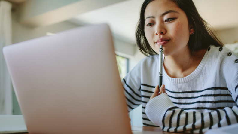 Woman sitting at computer doing research.