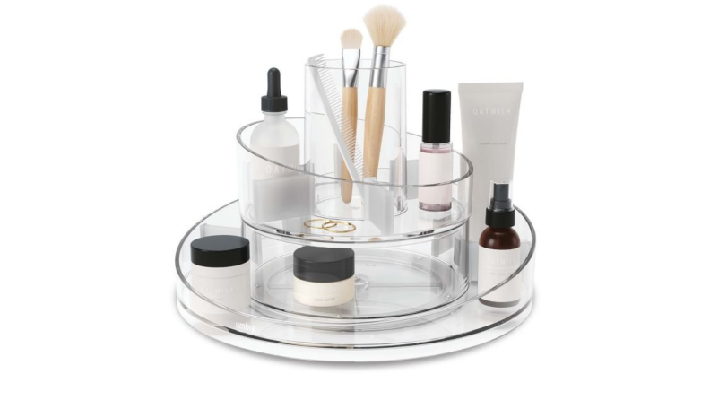 A stack of makeup on a display against a white background.