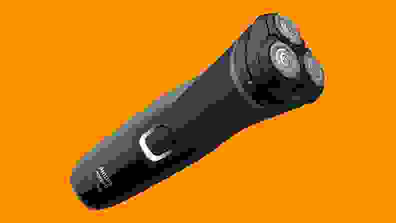 An electric shaver against an orange background.
