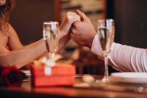 Couple holding hands with champagne