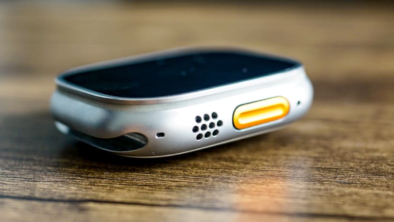 The Apple Watch Ultra sits on a tabletop, its Action button on display.