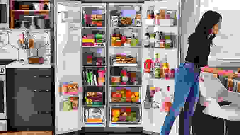 Image of person putting food into the fridge