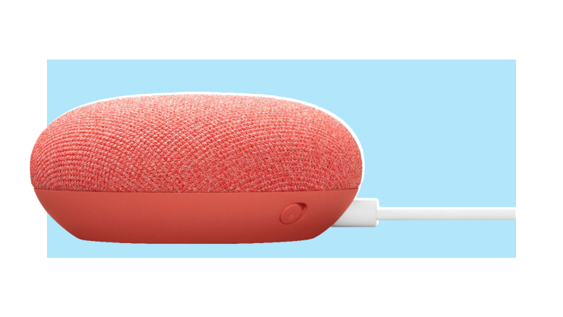 A Google Nest Mini smart speaker on a colorful background