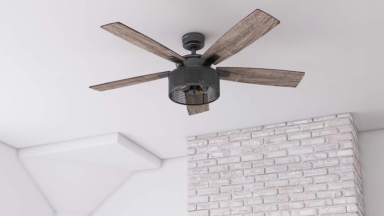 A Honeywell ceiling fan hangs from a white ceiling.