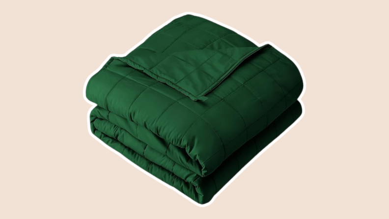 A dark green blanket on a pink backround.