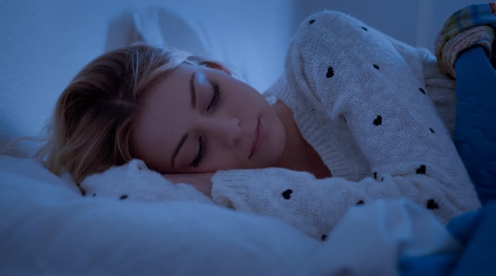 Kid sleeping in bed with lights off