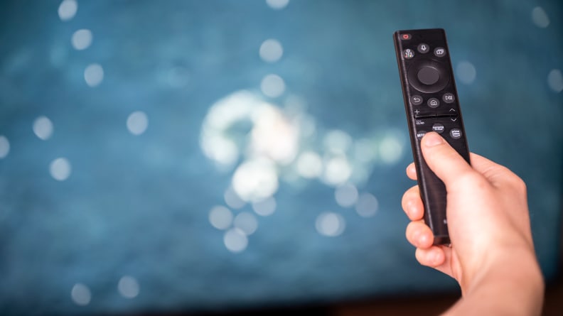 A close-up of the Samsung Solar Cell remote control being held in someone's hand