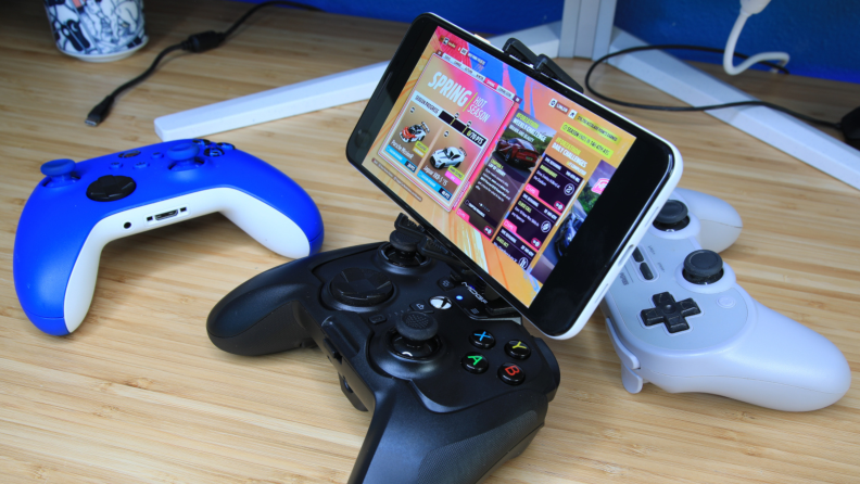 Three different PowerA MOGA XP-Ultra controllers' side-by-side, with a Smart phone mounted to one controller.