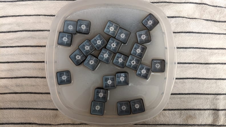 Keycaps floating upside down in soapy water