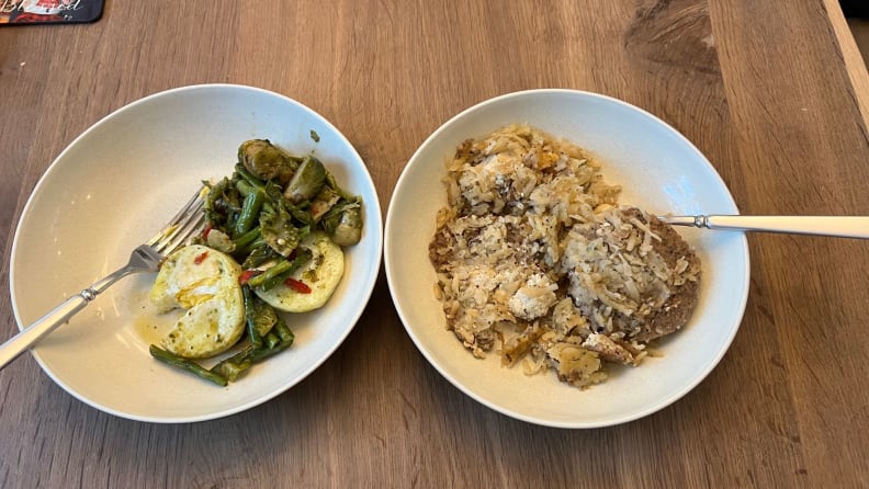 Two plates of prepared food.