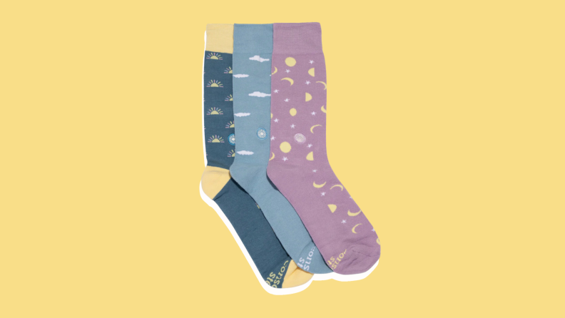 Three patterned socks on a yellow background.