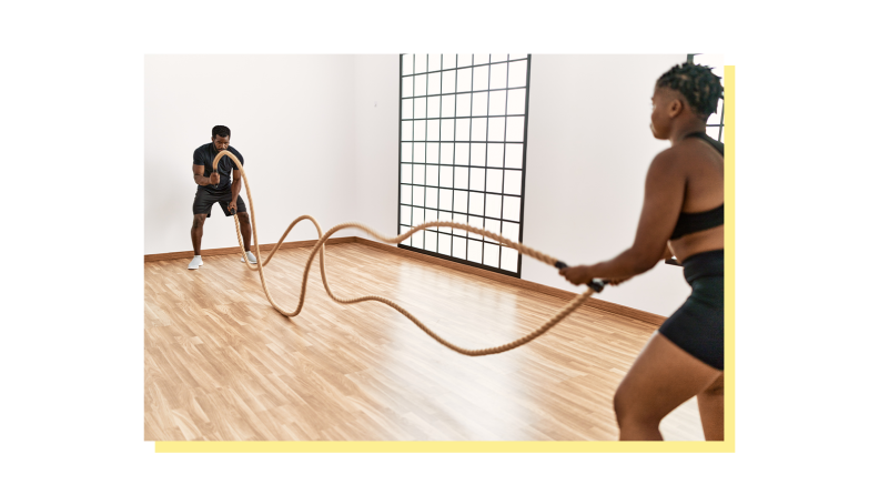 2 people using battle ropes from opposite ends