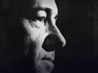A black-and-white image of Kevin Spacey's face, seen from the side.