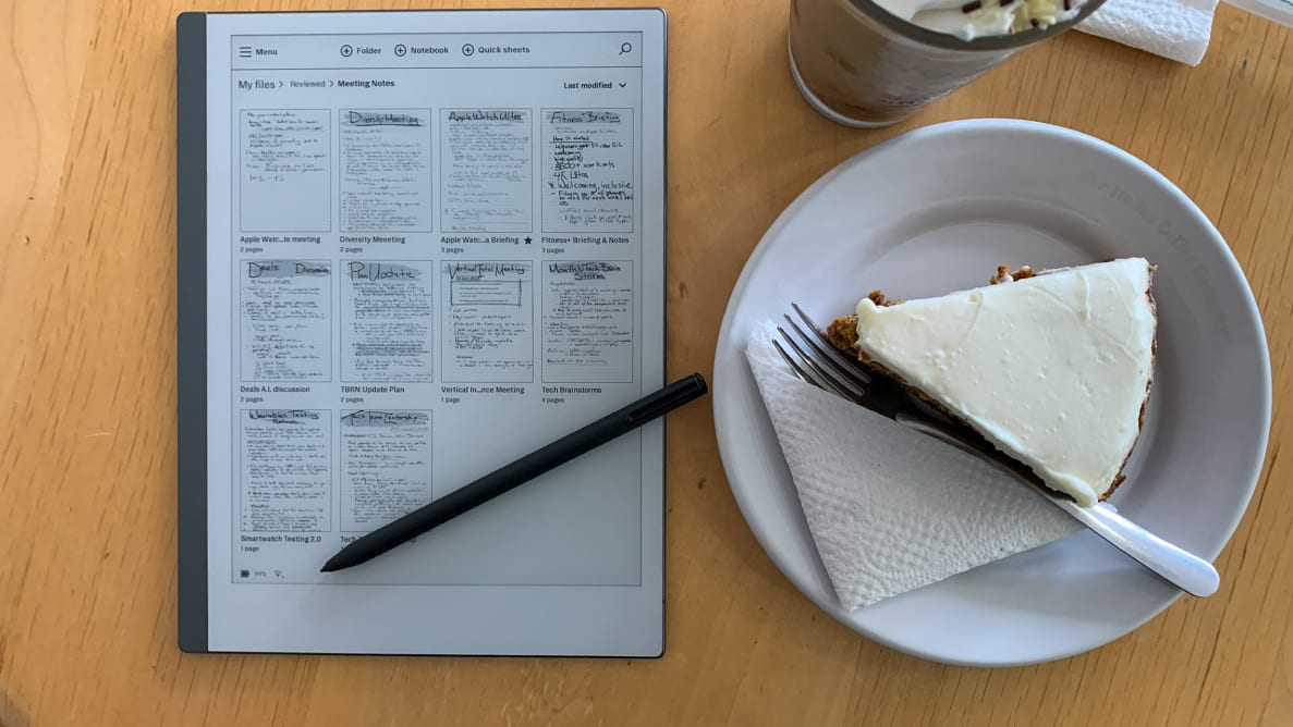 A reMarkable 2 tablet sits on a table next to a piece of carrot cake