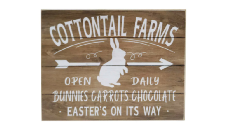 A wooden sign with a white bunny and lettering