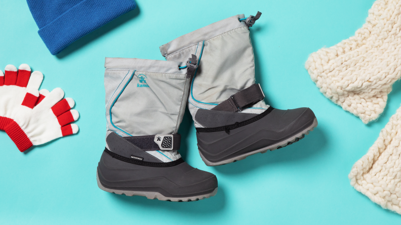 A pair of Kamik snowfall kids boots on a blue background
