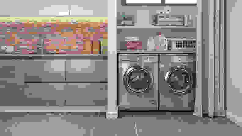 A stainless-steel washing machine and dryer nestled in a laundry room.