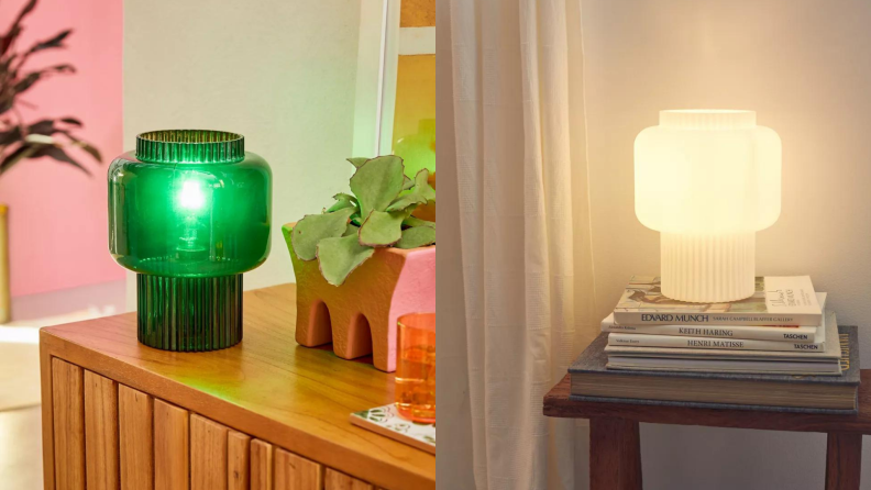 A glass lamp in emerald green on a natural wood dresser. On the right, the same lamp in white glass.