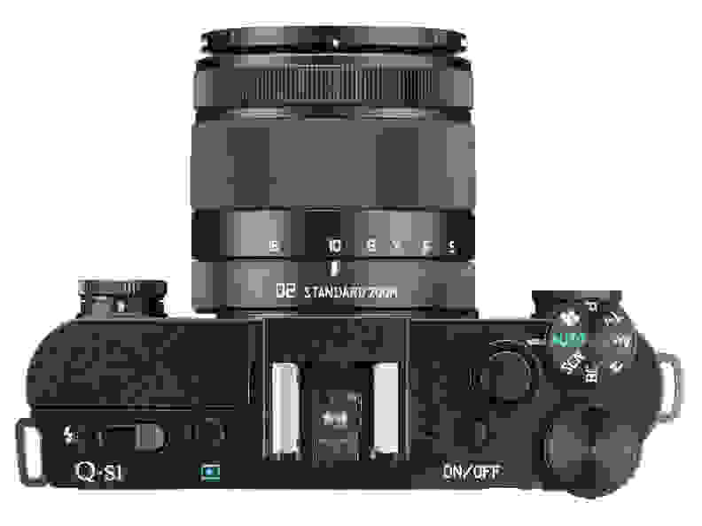 The Pentax Q-S1 retains the pop-out flash, hot shoe, and top plate control cluster from the Q7.