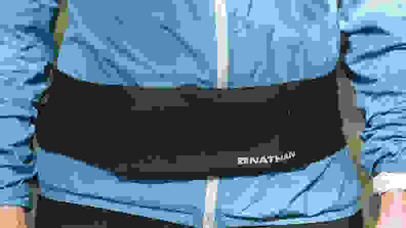 Person wearing Nathan Zipster running belt.