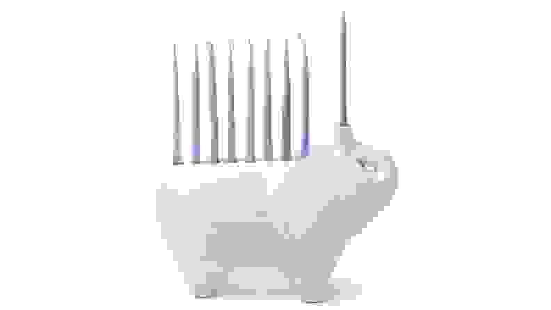 White elephant shaped menorah with pastel blue candle sticks sticking out of back.