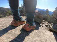 A hiker wearing a pair of Hoka running shoes
