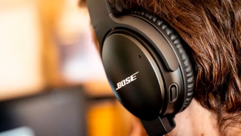 A person wears Bose headphones