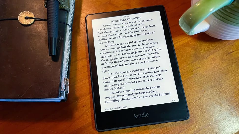 A Kindle tablet displaying a page of Nightmare Alley on the screen.