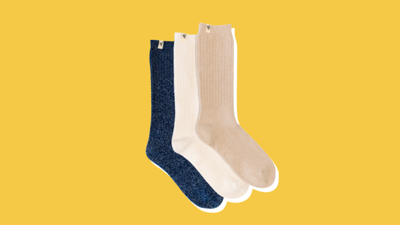 Three pairs of Cozy Earth Plush Lounge Socks stacked on top of each other on a yellow background.