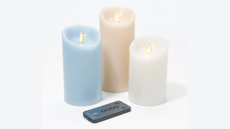 Three candles on a gray background