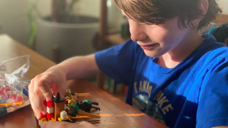 A child builds a mini Lego set