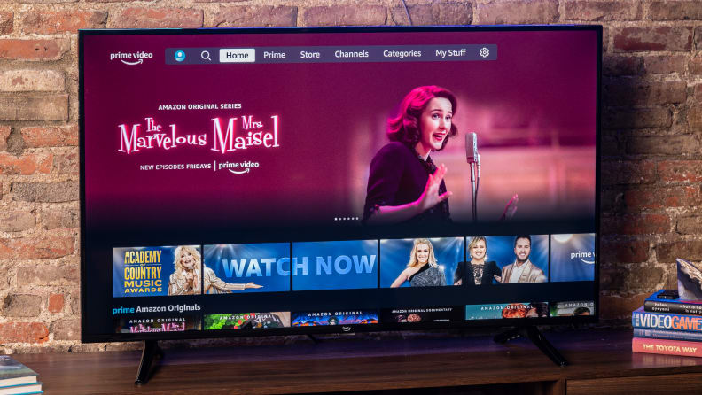 The Amazon Fire TV 4-Series displaying the Prime Video home screen in a living room setting