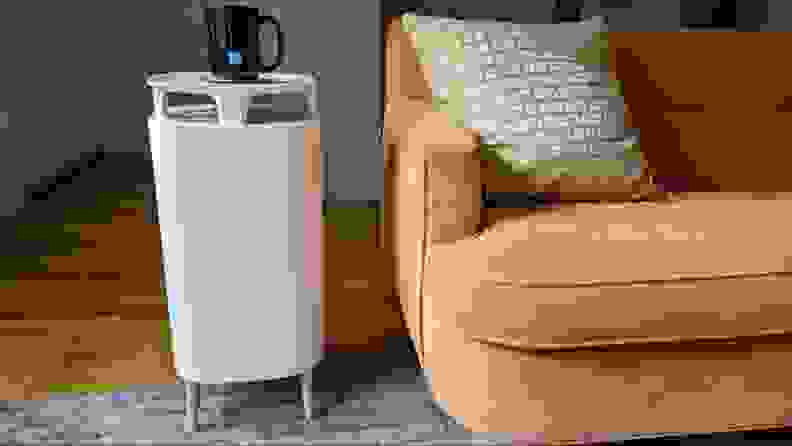 Air purifier sitting next to a couch