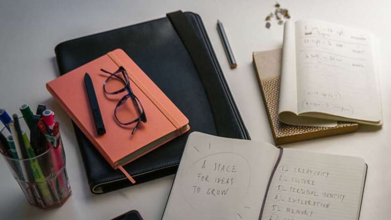 moleskine journals sit open on a table