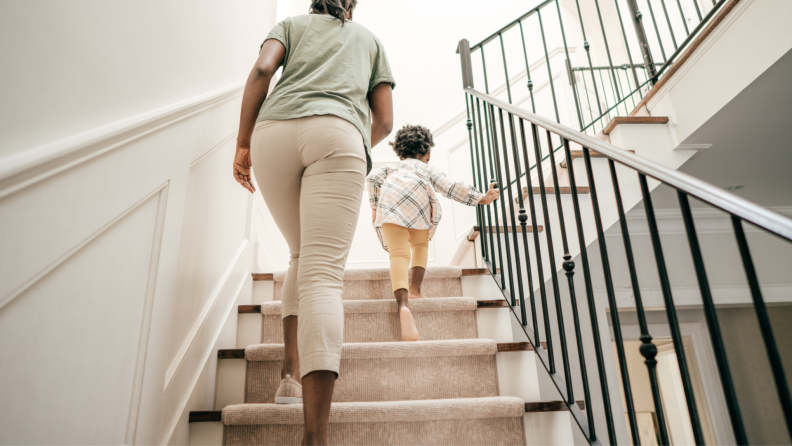 woman and child climbing carpeted stairs