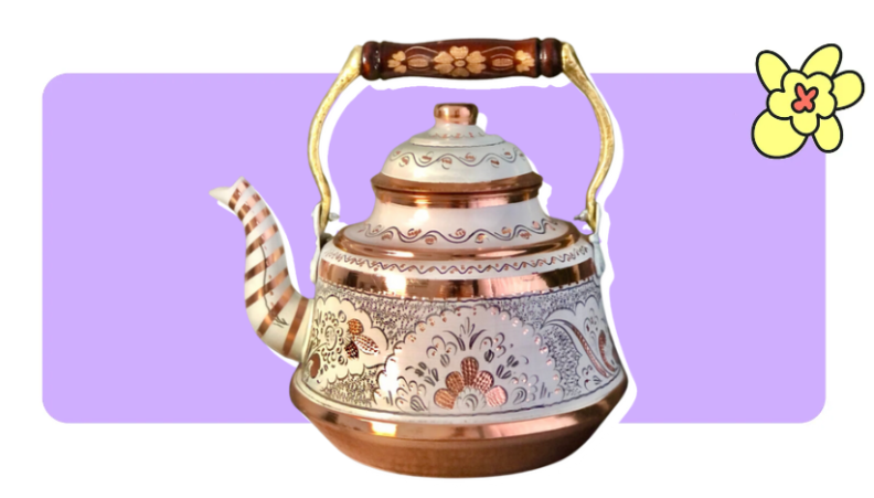 A rose gold and white hand-painted tea kettle in front of purple background with a yellow cartoon flower in the corner..