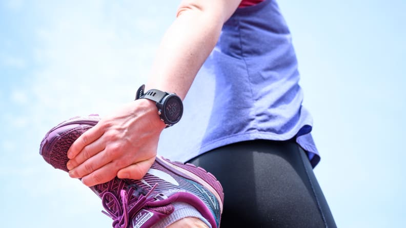 Female runner stretching hamstring