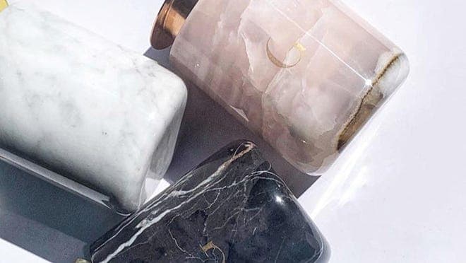 Candles in marbled containers.