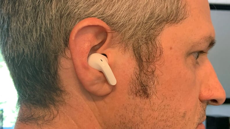 The profile of a man wearing the LG T90Q earbuds.