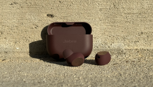The Jabra Elite 10 and the carrying case in an outdoor pavement.